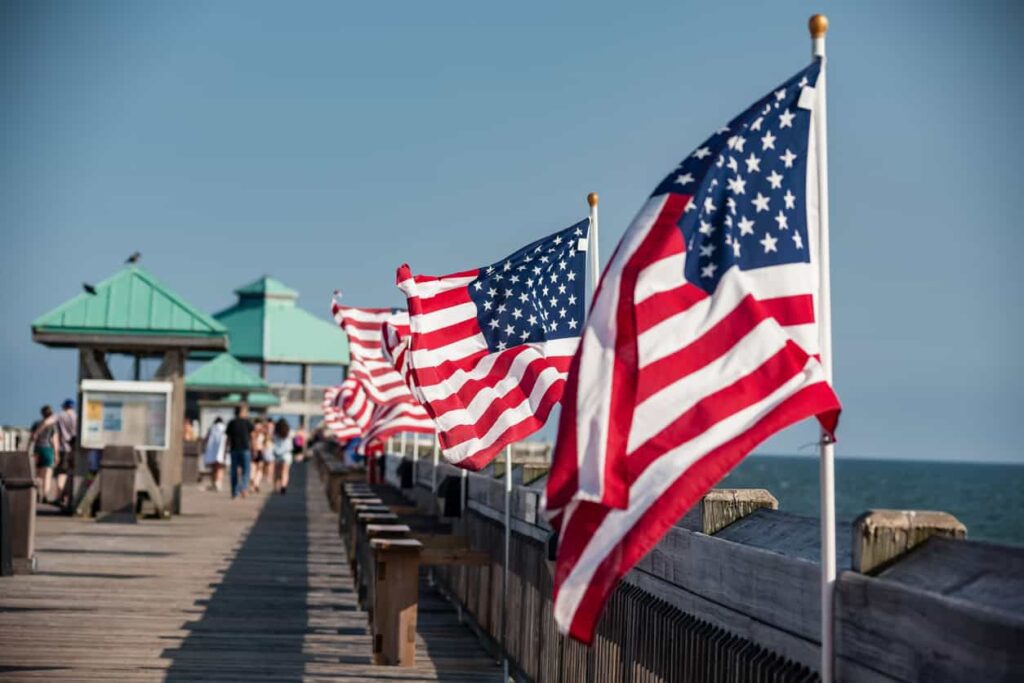 Line of American flags on pier.