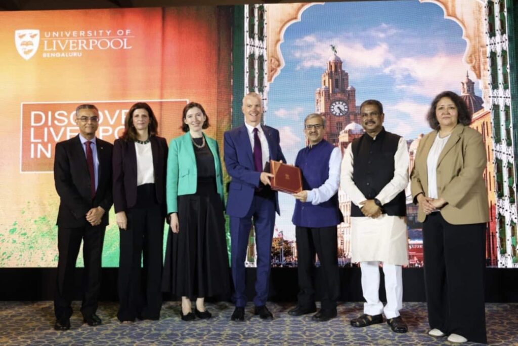 Stakeholders gather on stage holding a document