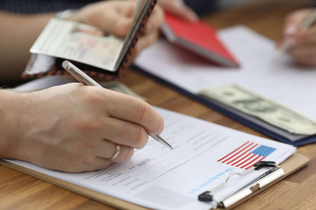 Person filling in US visa interview form.