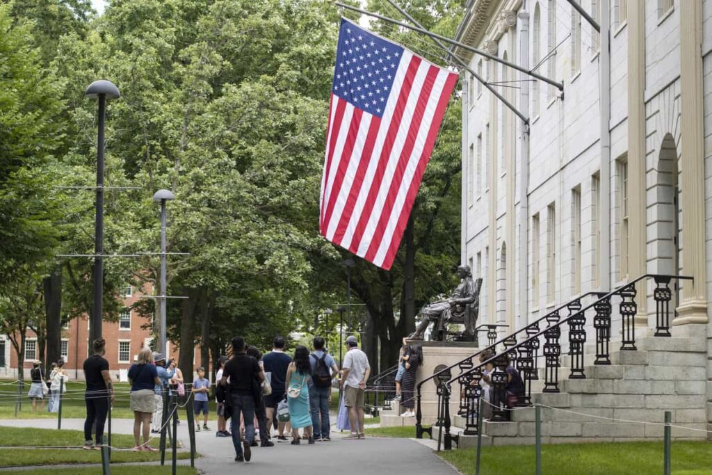 US flag flying outside Harvard University building.