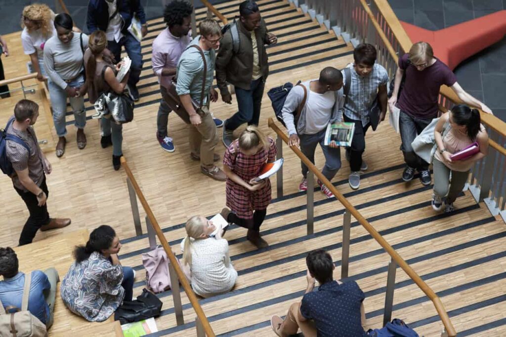 International students walking up stairs, pictured from above.