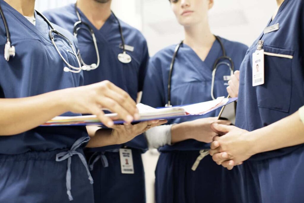 Group of doctors from neck down, holding clipboards.